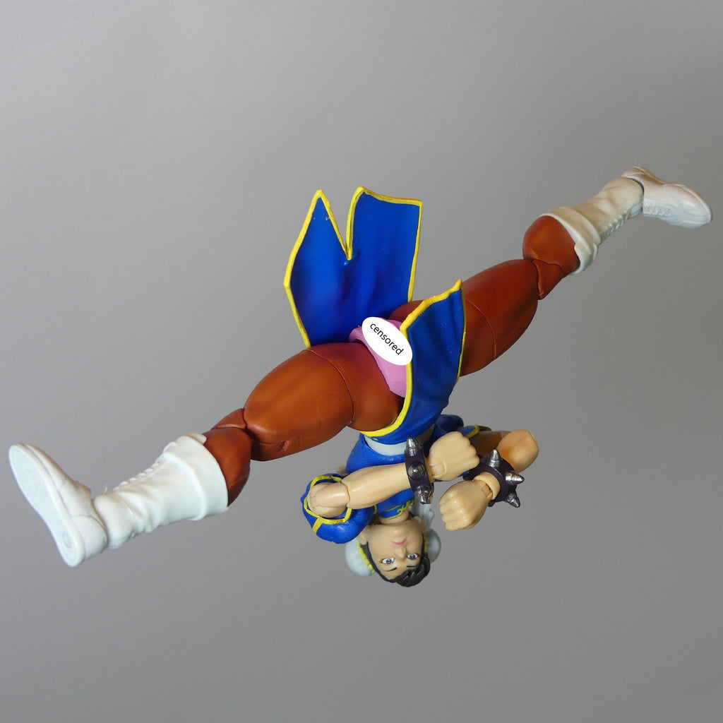 Street Fighter 6 Chun-Li action figure BarbieVagina posed upside down against a solid gray background.