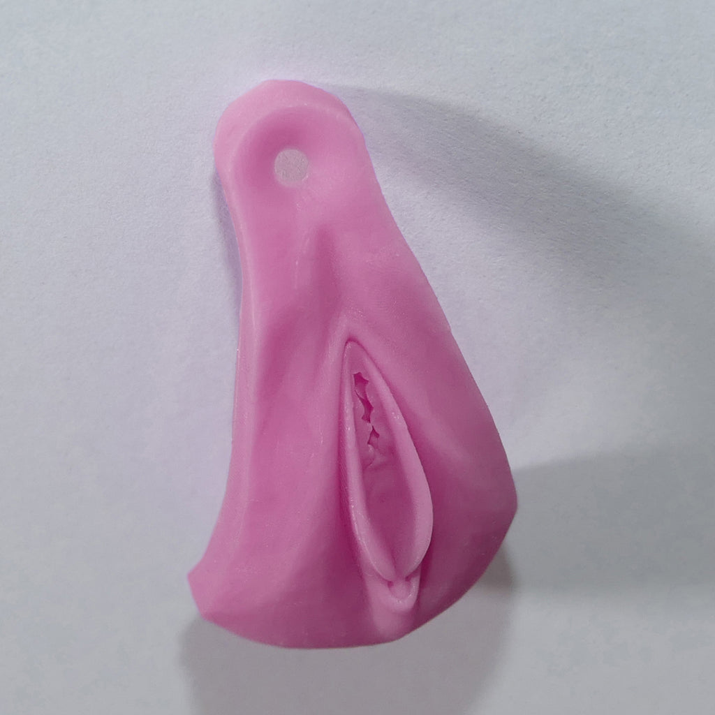 A pink silicone vagina adult novelty product with a textured, realistic interior design, shown on a plain light gray background.
