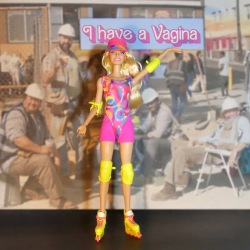 A Barbie-style roller skate doll figure stands centered against a blurred poster background. The figure has blonde hair, a pink outfit with a multicolor tie-dye pattern, bright yellow roller skates, and yellow wrist/ankle accessories.